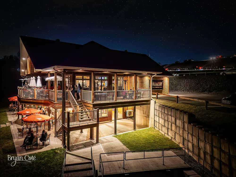 A night view of an outdoor area with a patio and stairs.